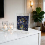 A Black Dzambhala acrylic frame displayed at the home entrance (foyer), acting as a spiritual guardian to protect the household's wealth and peace.