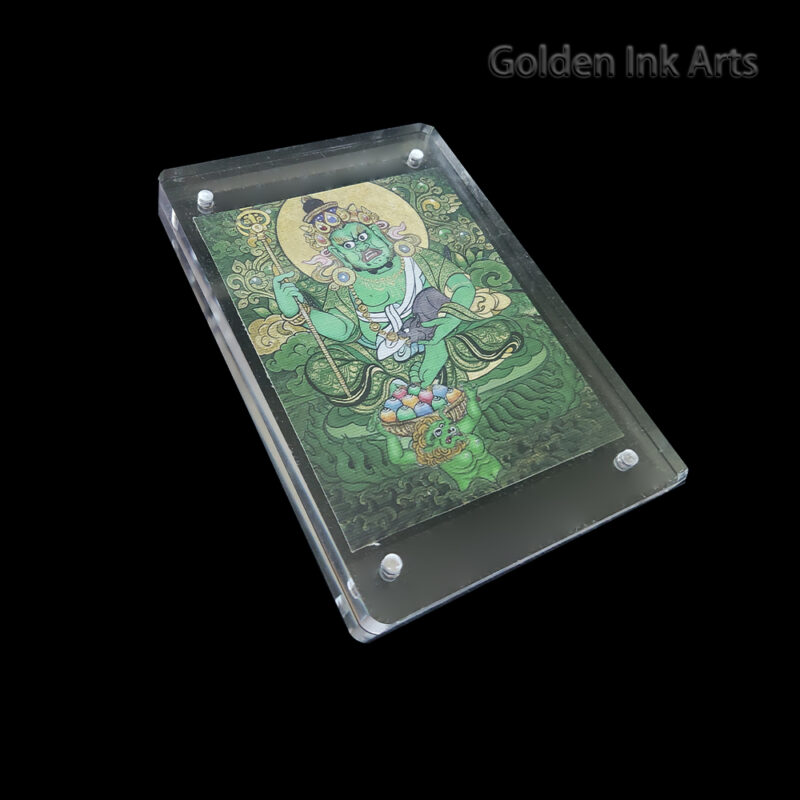 Side angled view of the Green Dzambhala acrylic frame, showing the organic texture of the natural cotton canvas and the clear protective case.