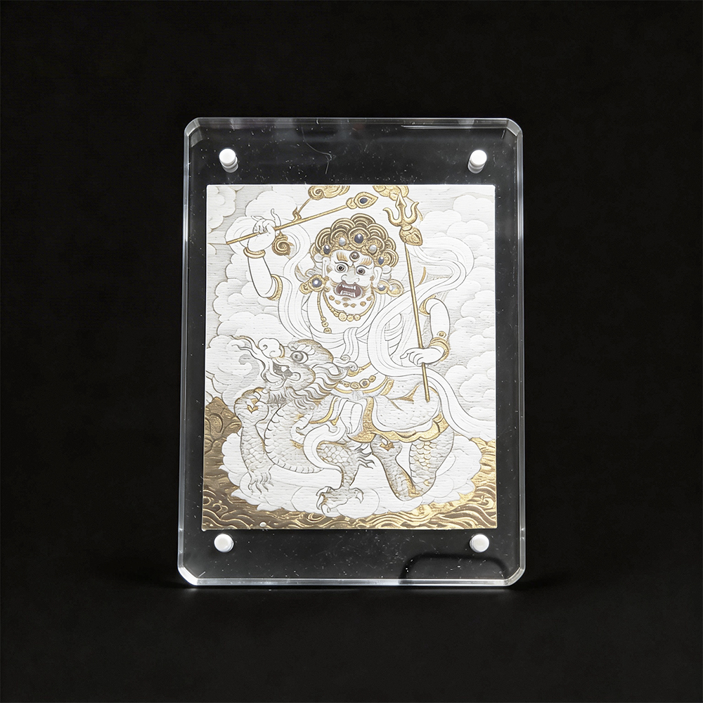 Direct front view of the White Dzambhala Buddhist art on unbleached cotton canvas, framed in a modern clear acrylic case for home protection