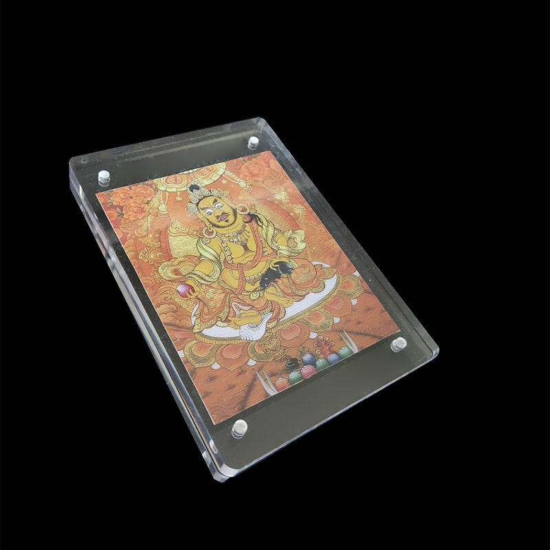 Side angled shot of the Yellow Dzambhala acrylic frame, showing the organic texture of the micro-spray cotton canvas and the sleek transparent depth.