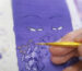 Hand-painting process of a purple Buddha Eyes Thangka with gold ink detailing and sacred geometry.