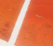 Close-up details of a hand-painted minimalist orange-red Thangka Buddha eye artwork showing intricate linework.