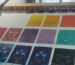 A collection of pure color Thangka paintings from the Buddha Eyes series, meticulously arranged and stretched on a traditional wooden drawing frame, representing the five elements energy