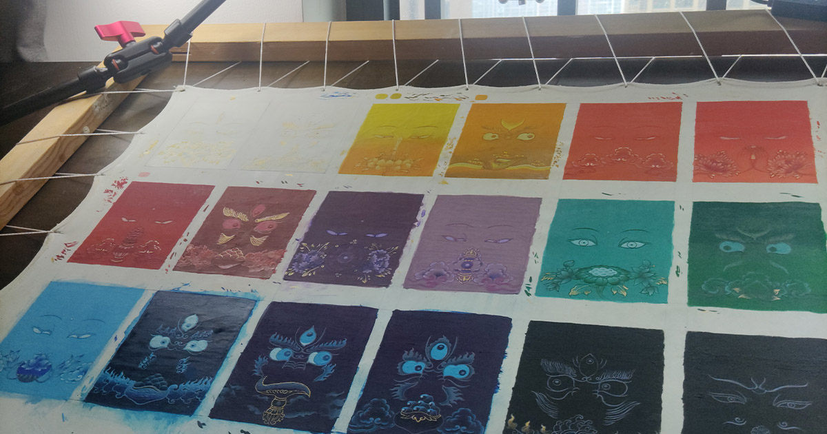 A collection of pure color Thangka paintings from the Buddha Eyes series, meticulously arranged and stretched on a traditional wooden drawing frame, representing the five elements energy
