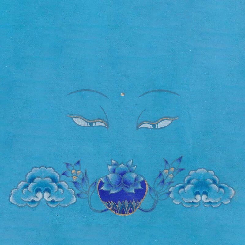 Serene blue Buddha eyes looking softly down at a lapis-blue medicine bowl adorned with lotus petals and cloud motifs on an azure blue textured background.
