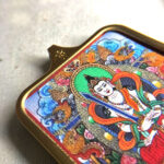 Close-up of Akasagarbha Bodhisattva pendant in gold Gau box for zodiac guardian meditation.