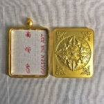 Openable view of the brass Gau box displaying backside art and sacred inner compartment.