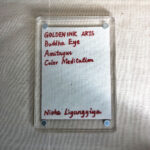 Backside of clear acrylic frame displaying artist signature card and magnetic corner screws.
