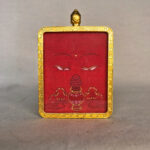 Frontal view of Amitayus Buddha Eyes pendant for Root Chakra color meditation.