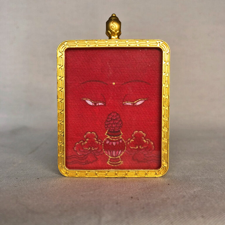 Frontal view of Amitayus Buddha Eyes pendant for Root Chakra color meditation.