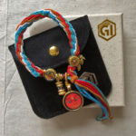 Amitayus Buddha Eyes bracelet displayed with black velvet pouch and Golden Ink Arts box.