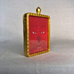 Three-quarter side angle of Amitayus Buddha Eyes gold brass Gau box pendant.