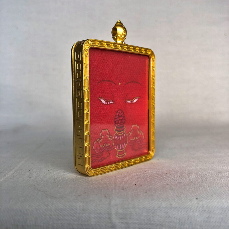 Three-quarter side angle of Amitayus Buddha Eyes gold brass Gau box pendant.