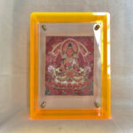 Front view of red Amitayus Thangka print in a yellow floating translucent acrylic frame.