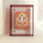 Front view of orange Four-Armed Avalokiteshvara Thangka print in a red floating acrylic frame.