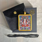 Four-Armed Avalokiteshvara Gau box necklace displayed with black cord, velvet pouch, and gift box.