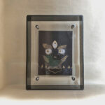 Front view of Black Jambhala Buddha Eyes print in a black floating translucent acrylic frame.