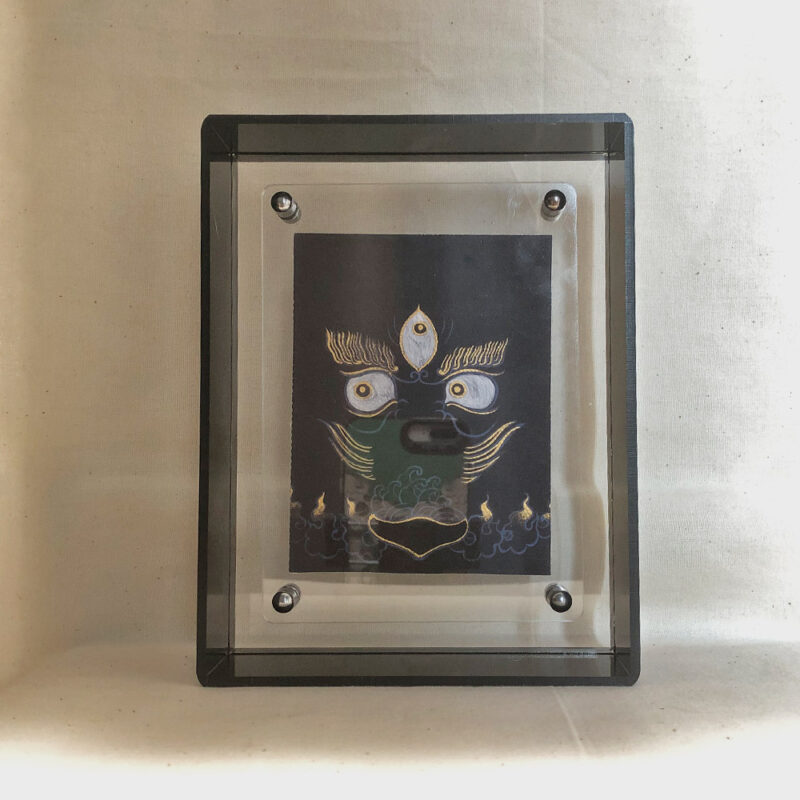 Front view of Black Jambhala Buddha Eyes print in a black floating translucent acrylic frame.