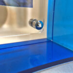 Close-up of magnetic corner screw on sapphire blue translucent acrylic display block.