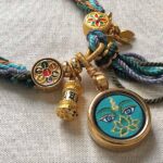 A handmade 1.5cm Buddha Eye meditation bracelet with woven cords and gold charms