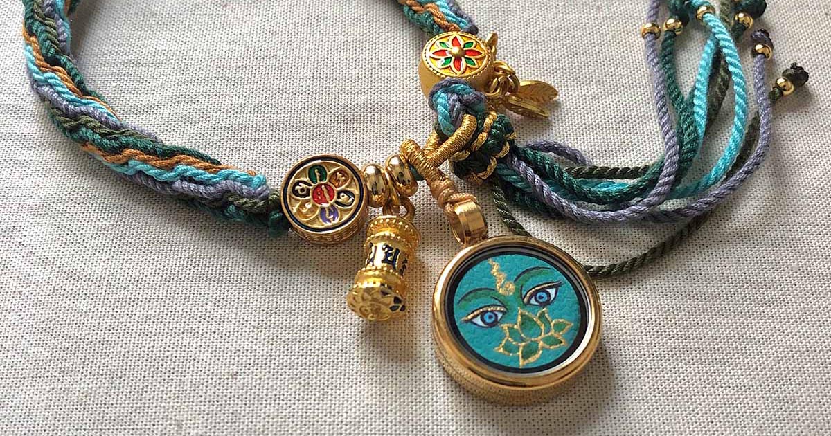 A handmade 1.5cm Buddha Eye meditation bracelet with woven cords and gold charms