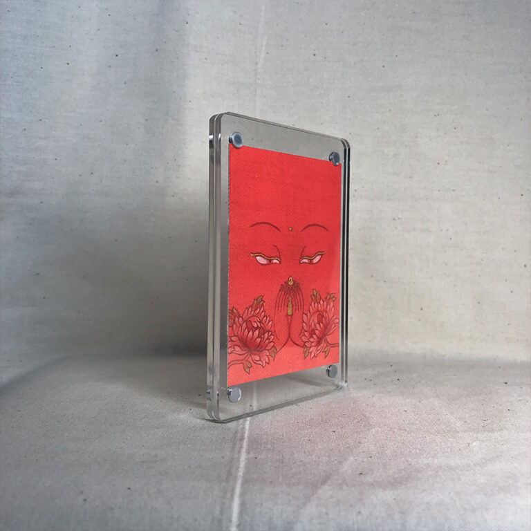 Side-angle view of freestanding clear acrylic block displaying Four-Armed Avalokiteshvara line art.