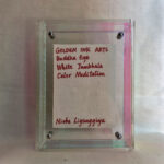 Back view of clear acrylic frame displaying Golden Ink Arts custom branding card and signature.