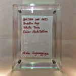 Back view of clear acrylic frame displaying Golden Ink Arts custom branding card and signature.