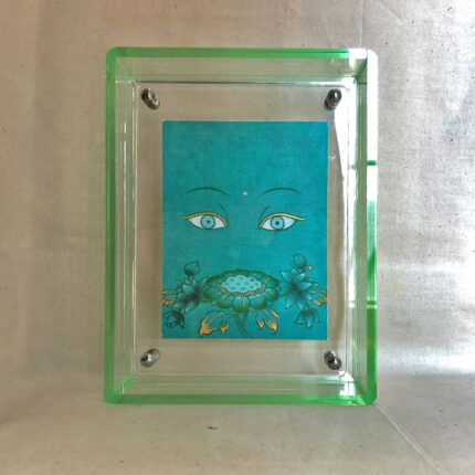 Front view of Green Tara Buddha Eyes print in a green floating translucent acrylic frame.