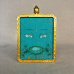 Frontal view of Green Tara Buddha Eyes pendant for Heart Chakra color meditation.