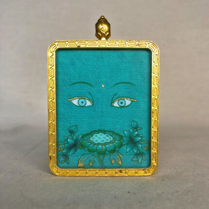 Frontal view of Green Tara Buddha Eyes pendant for Heart Chakra color meditation.