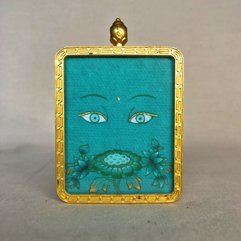 Frontal view of Green Tara Buddha Eyes pendant for Heart Chakra color meditation.