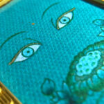 Macro detail of hand-painted gold linework on Green Tara Buddha Eyes green fine art canvas.