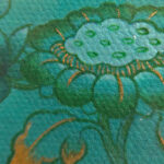 Close-up of original hand-painted gold lotus linework and wisdom eyes on green canvas texture.