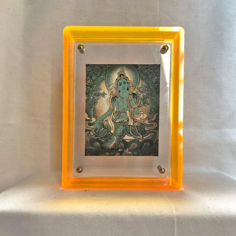Front view of Green Tara Thangka print in a yellow floating translucent acrylic frame.