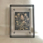 Front view of Guru Rinpoche Thangka print in a black floating translucent acrylic frame.