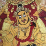 Close-up of HD giclée Yellow Jambhala Thangka print showing golden deity features and fine line work.