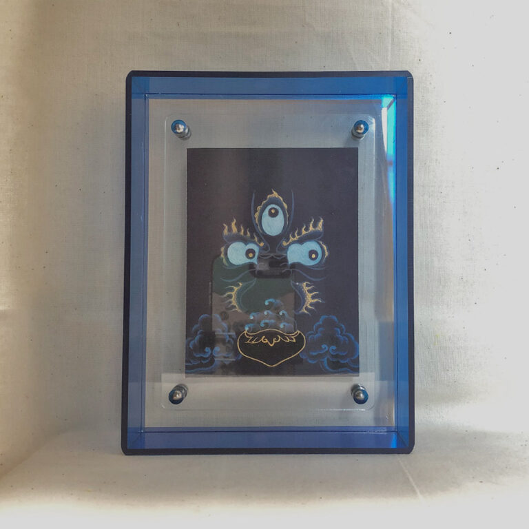 Front view of indigo Mahakala Buddha Eyes print in a blue floating translucent acrylic frame.