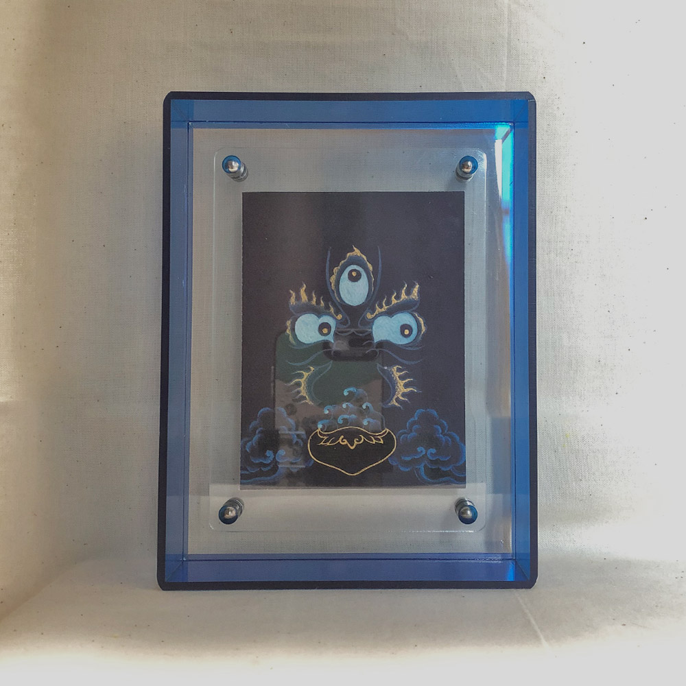 indigo-mahakala-art-blue-acrylic-frame-front Front view of indigo Mahakala Buddha Eyes print in a blue floating translucent acrylic frame.