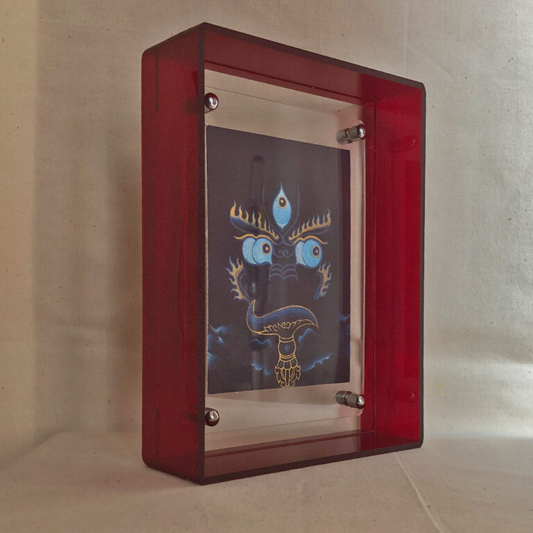 Side perspective of indigo Yamantaka Buddha Eyes art inside a red translucent acrylic frame.