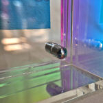 Close-up of magnetic corner screw on iridescent aurora acrylic display block.