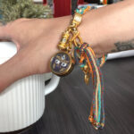 Indigo Mahakala Buddha Eyes charm bracelet worn on wrist for daily protection and mindfulness.