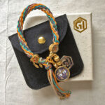 Mahakala indigo bracelet presented with velvet pouch and Golden Ink Arts branded gift box.