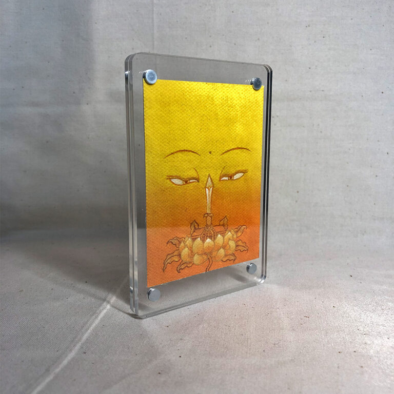 Side-angle view of freestanding clear acrylic block displaying Manjushri line art.