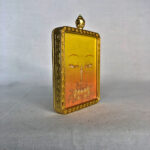 Three-quarter side angle of Manjushri Buddha Eyes gold brass Gau box pendant.