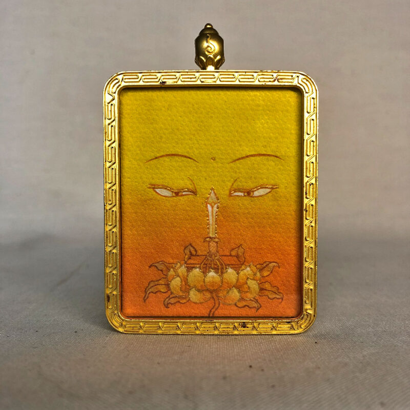 Frontal view of Manjushri Buddha Eyes pendant for Solar Plexus Chakra color meditation.