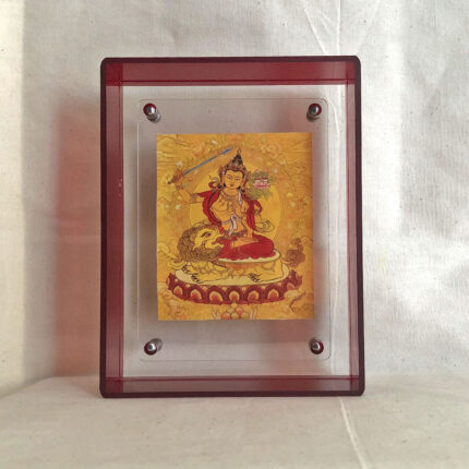 Front view of golden Manjushri Bodhisattva Thangka print in a red floating acrylic frame.
