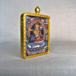 Side-angle view of Manjushri Bodhisattva brass Gau box necklace pendant.