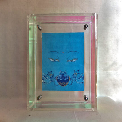 Front view of Medicine Buddha Eyes print in an iridescent floating translucent acrylic frame.