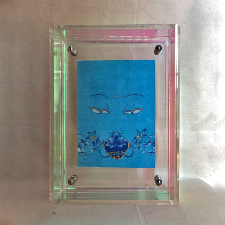 Front view of Medicine Buddha Eyes print in an iridescent floating translucent acrylic frame.